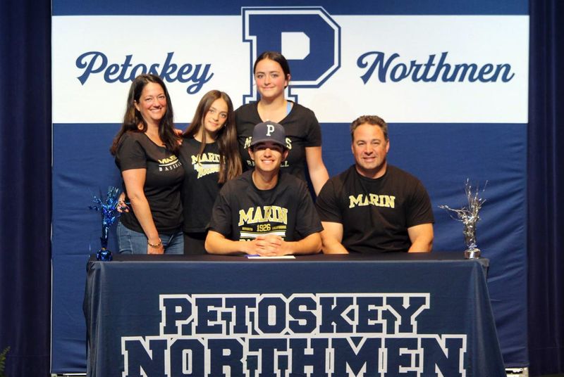 Petoskey senior baseball player Tyler Pool, joined by his family, made it official with the College of Marin baseball team in California last week.