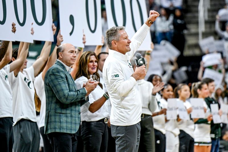 Michigan State University President Kevin Guskiewicz rallies the fans during a halftime ceremony celebrating Greg and Dawn Williams $401 million donation to the university on Saturday, Dec. 6, 2025, during the Spartans basketball game against Duke at the Breslin Center in East Lansing.