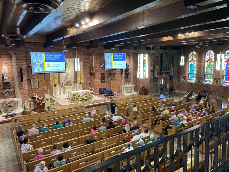 Catholics gather at St. André Bessette Catholic Church in Ecorse, Michigan, on April 14, 2026, listening to Rev. Mario Amore, director of parish renewal at the Archdiocese of Detroit, seen in this photo standing in aisle, for a listening session to gather input about how to restructure parishes in the archdiocese.