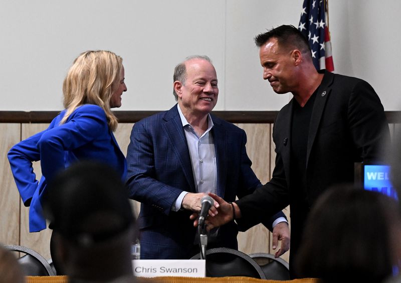 Secretary of State Jocelyn Benson (left), former Detroit Mayor Mike Duggan and Genesee County Sheriff Chris Swanson greet each other after a United Auto Workers forum for gubernatorial candidates on May 18 at UAW Local 600 in Dearborn. Three days after the event, Duggan ended his independent campaign for governor, citing a national shift in political winds favoring Democrats, like Benson and Swanson.