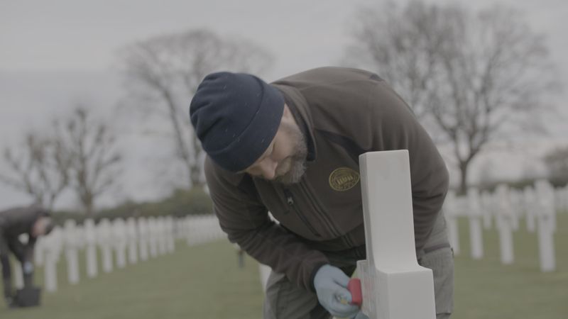 A member of staff at the Netherlands American Cemetery at Margraten polishes a headstone ahead of Memorial Day.