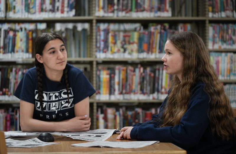 Okemos High School junior Sydney Demshur, right, speaks about the demise of the student-led Okemos High School student newspaper The OHS Press, Monday, May 18, 2026, during an interview at the Okemos Library in Meridian Township. Also pictured is associate editor Miki Perdikakis.
