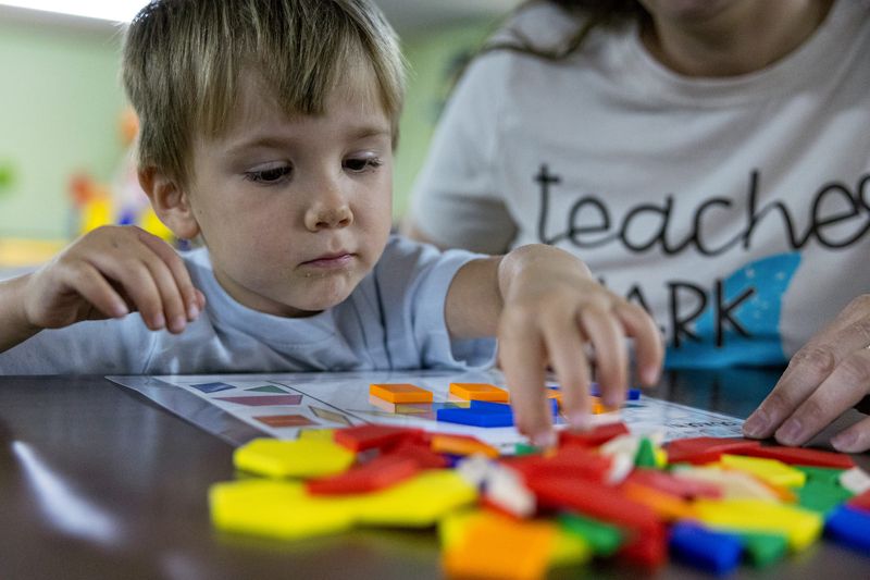 Kayla Wright sits down with a student for one-on-one time on Monday, May 18 at Kayla’s Kiddos Childcare.