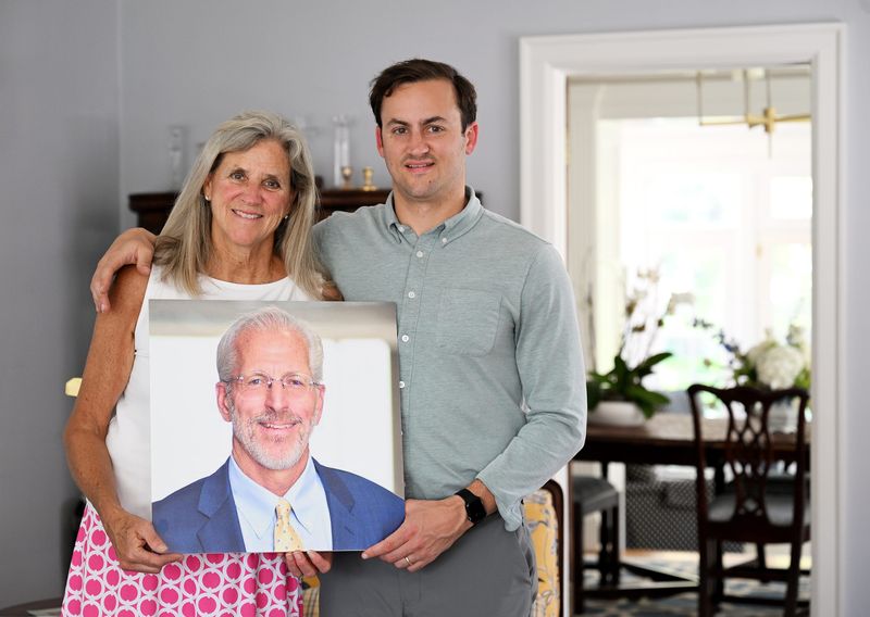Betsy Bernard and her son, Jack Bernard, are photographed with a photo of Michael Bernard, Michiganian of the Year, on May 19, 2026 at the Bernard home in Grosse Pointe, Mich. Michael Bernard, Betsy’s husband died in February 2026.