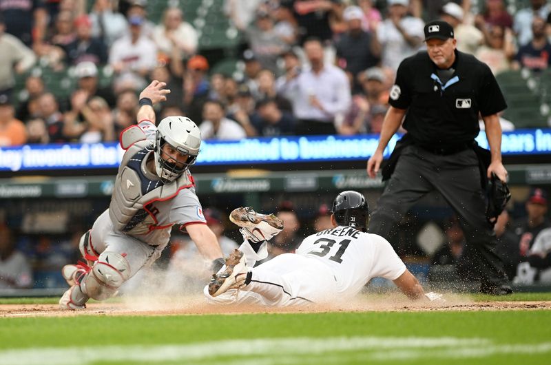 Tigers’ Riley Greene scores on a throwing error beating a tag by Guardians catcher Austin Hedges in the fourth inning. Detroit Tigers take on the Cleveland Guardians on May 19, 2026 at Comerica Park in Detroit.