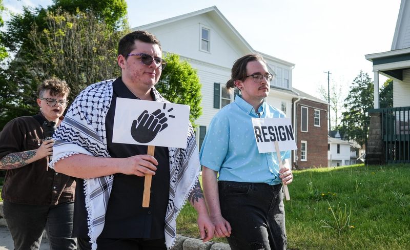 Demonstrators march toward the Hannah Community Center, Tuesday, May 19, 2026, to attend the East Lansing City Council meeting where many voiced their concerns and demands to city leadership regarding the death of Isaiah Kirby, who was shot and killed by police last month.