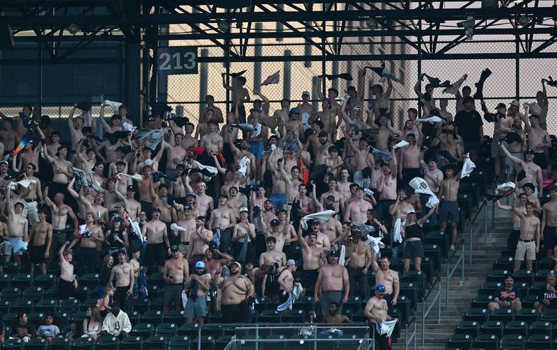 Shirtless men wave their shirts in the air in section 213 in the eighth inning. Detroit Tigers take on the Cleveland Guardians on May 19, 2026 at Comerica Park in Detroit.