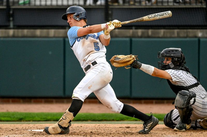 Lansing Catholic's Ethan Link drives in two runs against Williamston in the sixth inning on Tuesday, May 19, 2026, during the Diamond Classic at McLane Stadium in East Lansing.