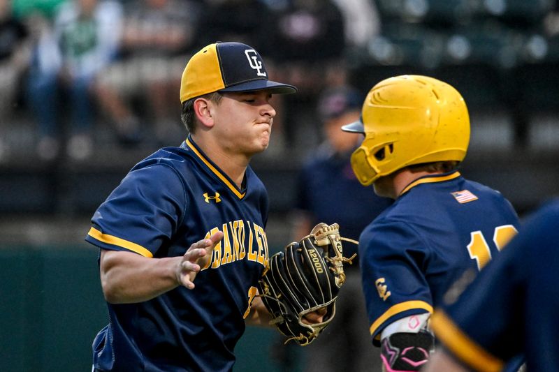 Grand Ledge's Michael Bos, left, celebrates with teammates after pitching a strikeout against Portland St. Patrick to end the inning on Tuesday, May 19, 2026, during the Diamond Classic at McLane Stadium in East Lansing.