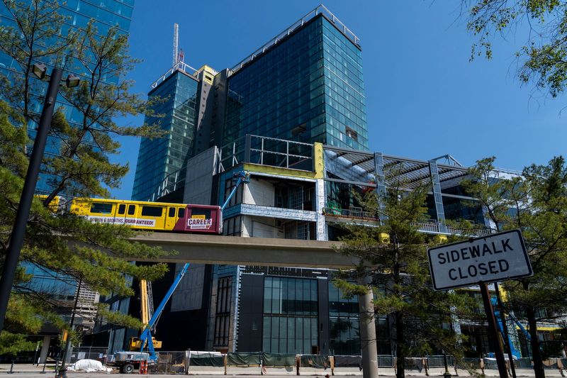 The People Mover passes in front of the future JW Marriott Detroit Water Square hotel development at the former Joe Louis Arena site in downtown Detroit on Tuesday, May 19, 2026. The 25-story luxury hotel is expected to open in 2027.