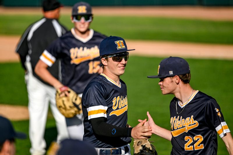 Haslett's Austin Prinz, left, and Matthew Hood celebrate the win over Portland after 5 innings on Wednesday, May 20, 2026, during the Diamond Classic at McLane Stadium in East Lansing.