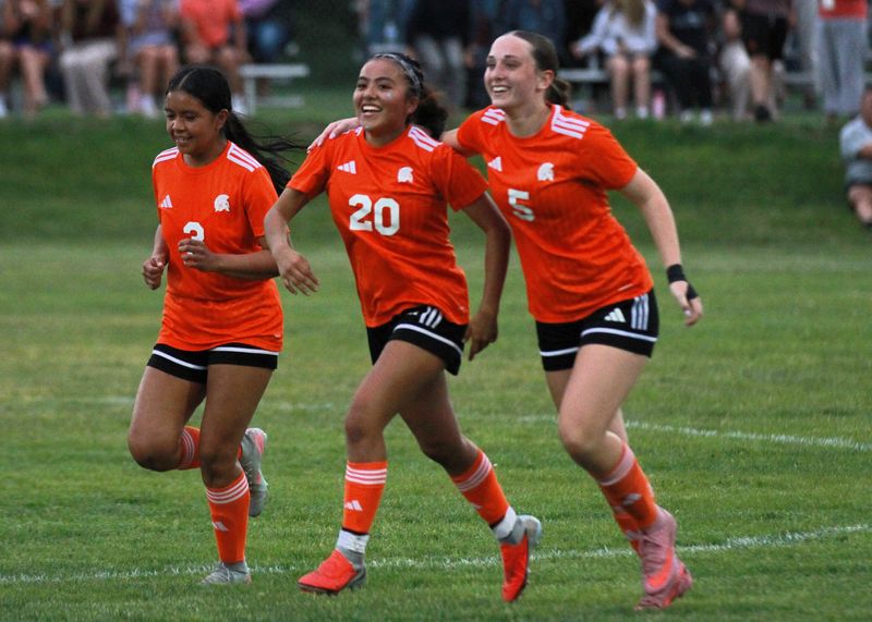 Aymee Reyes (3) and Maggie Frost (5) celebrate with Lashmy Garcia after she scored the second goal for Sturgis on Tuesday.