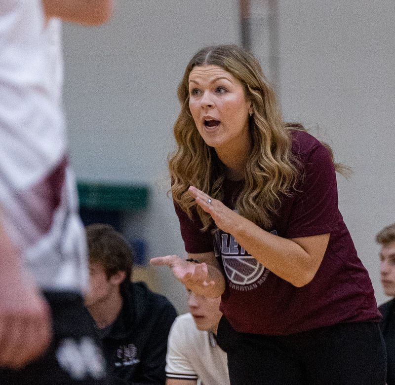 Coach Mackenzie Benham from Holland Christian claps after her team scores against West Ottawa on Wednesday, May 20.