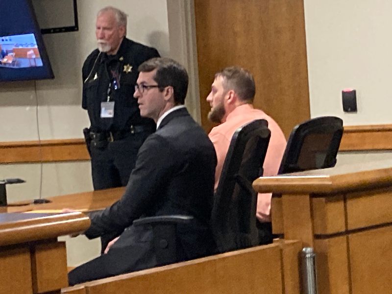 Former Michigan Department of Corrections sergeant Casey Wagner (right), sits in Ionia District Court with his Flint attorney, Michael Taylor, on May 21, 2026, as Wagner learns he has been federally indicted on weapons and other charges.