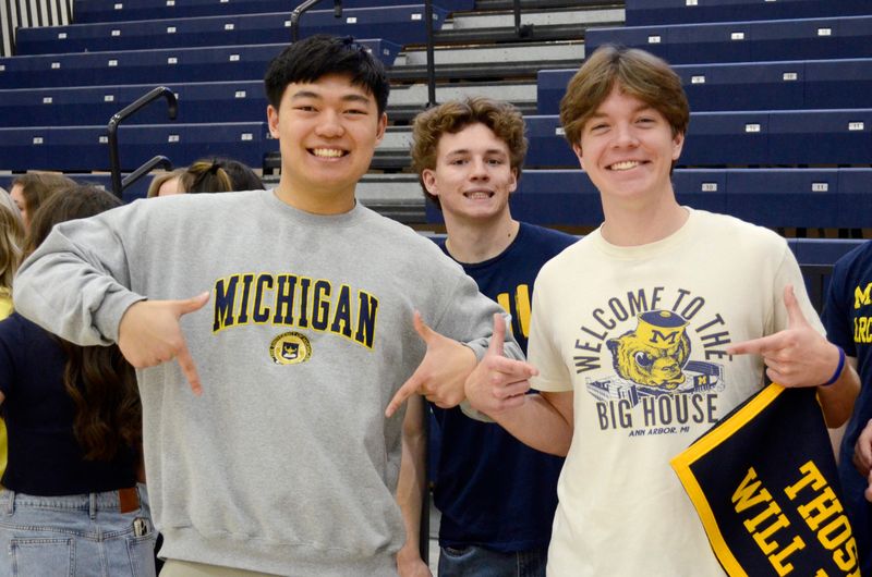 Brian Tang, Zahar Rush and Cullen Neal represent the University of Michigan during Decision Day at Petoskey High School on May 21, 2026.
