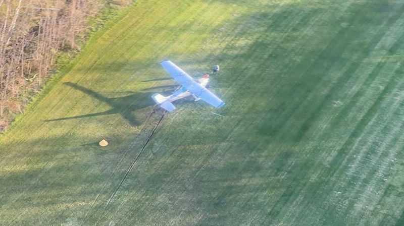 A crashed aircraft lays on the air strip of North Fox Island in Lake Michigan on May 20, 2026. A Coast Guard Air Station Traverse City MH-60 Jayhawk aircrew transported two people in stable condition after launching and arriving on scene.