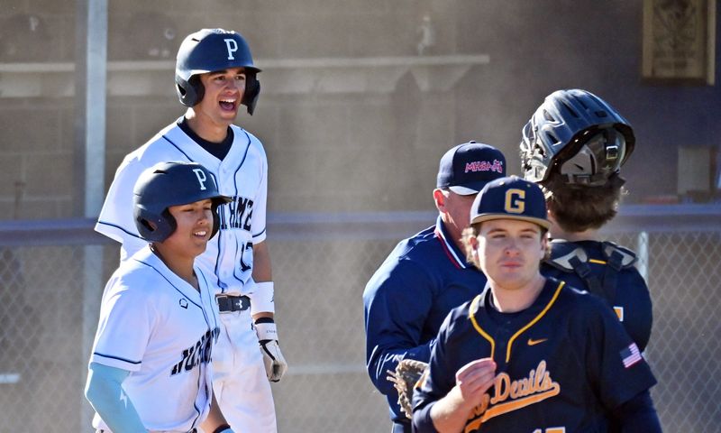 Petoskey's Tyler Pool (back, left) celebrates, along with teammate Mateo Lange, a victory over Gaylord on Thursday, May 21 at Turcott Field in Petoskey.