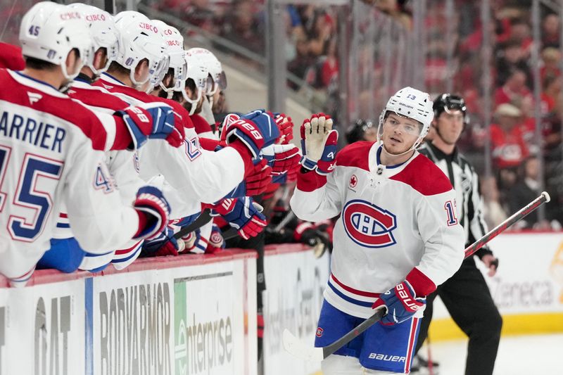 Canadiens right wing Cole Caufield (13) celebrates with teammates after scoring a goal against the Hurricanes during the first period in Game 1 of the Eastern Conference Final on Thursday at Lenovo Center.