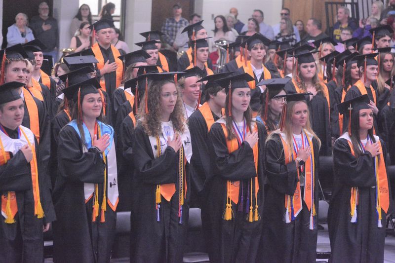 Cheboygan High School 2026 graduates recite the Pledge of Allegiance during the early stages of their graduation ceremony at the high school gymnasium on Friday, May 22.