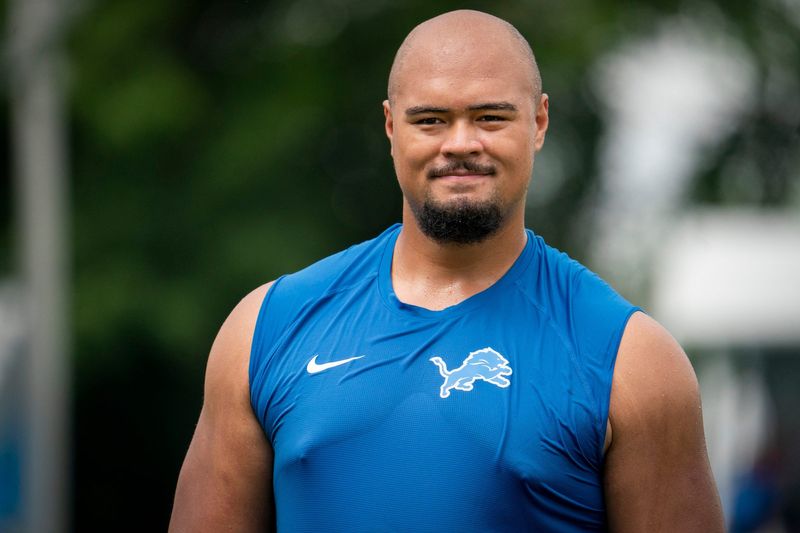 Newly drafted Lion Giovanni Manu walks off the field after he works out at practice with fellow offensive lineman on Tuesday, July 30, 2024 at the Lions practice facility in Allen Park.