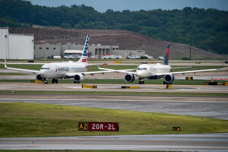 An American Airlines and a Delta Airlines plane taxi on their way to depart from Nashville International Airport in Nashville, Tenn., Saturday, May 23, 2026.