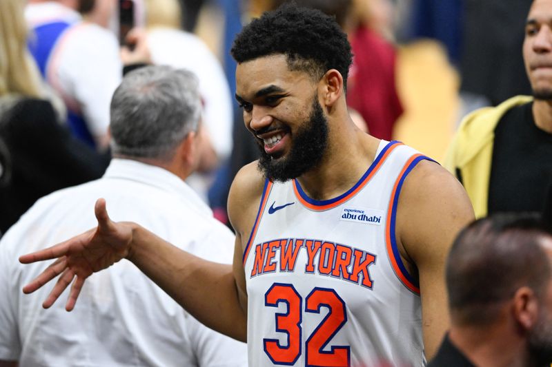 New York Knicks center Karl-Anthony Towns (32) high fives teammates after defeating the Cleveland Cavaliers in Game 3.