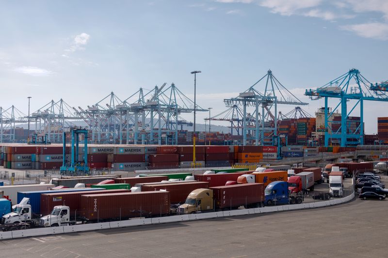 Tractor trailers carrying shipping containers at the Port of Los Angeles in Los Angeles, California, US, on Thursday, Aug. 28, 2025.