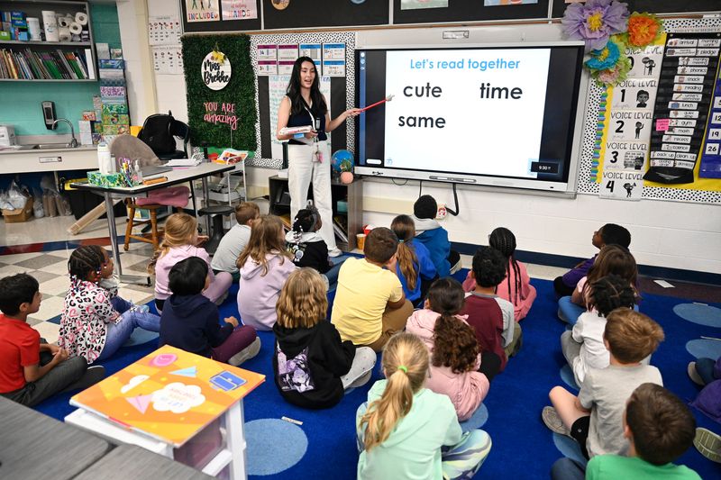 Field Elementary second grade teacher Grace Brekke. standing, teaches reading using the “UFLI" program, Thursday, Oct. 9, 2025, in Canton, Mich. UFLI stands for University of Florida Literacy Institute. Some of the lessons that are used by the teacher include phonemic awareness, visual drill, as well as several other parts of the teaching routine.