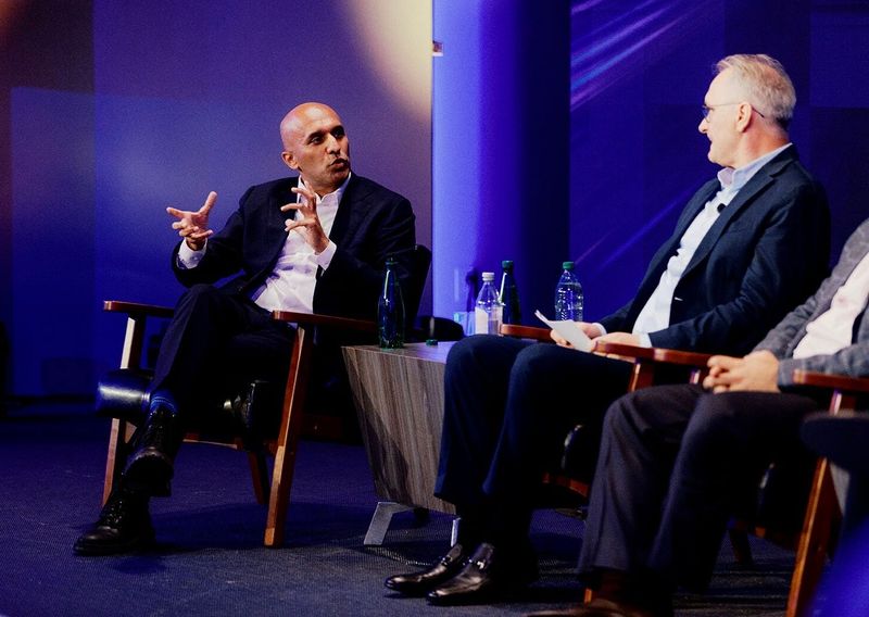 Applied Intution CEO Qasar Younis, left, speaks with Ned Curic, Stellantis' chief technology officer, at Stellantis' investor day in Auburn Hills. Younis is among the Silicon Valley executives assisting U.S. automakers as they scale up their software capabilities to compete with China.