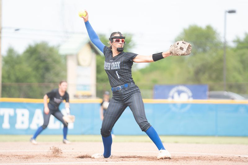 Harper Creek's Aleena Stahlhood pitches during a playoff game against Pennfield at Harper Creek High School on Tuesday, May 26, 2026.