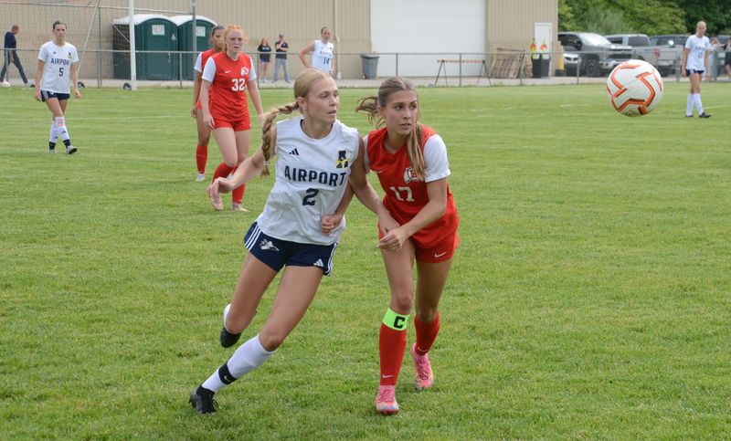 Olivia Gratz of Airport (left) and New Boston Huron's Ava Banko keep their eyes on the ball during a 4-0 Huron win in the semifinals of the Division 2 District at Tecumseh on Tuesday, May 26, 2026.