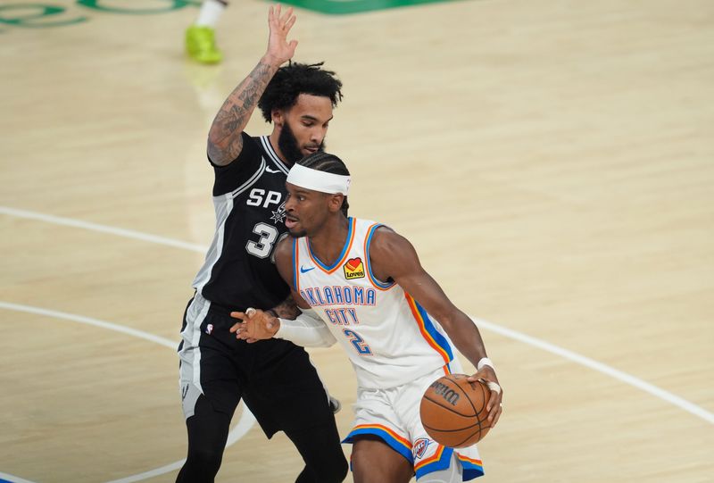 Oklahoma City Thunder guard Shai Gilgeous-Alexander (2) drives to the basketball against San Antonio Spurs forward Julian Champagnie (30) during the first quarter of Game 5 of the Western Conference finals at Paycom Center on Tuesday, May 26, 2026.