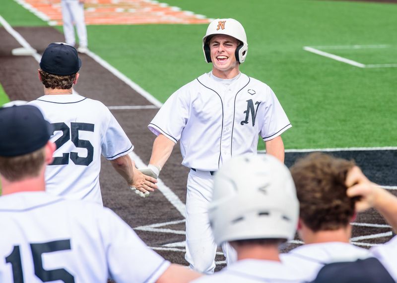 Northville's Macklin Hart celebrates scoring a run during the Division 1 baseball pre-district on Tuesday, May 26, 2026, at Northville High School.