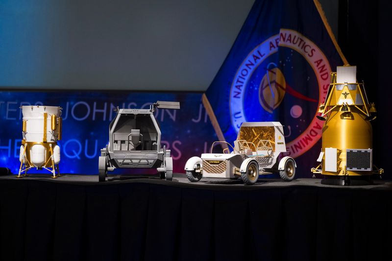Models of the Blue Origin Mark 1 Lunar Lander, from left, Astrolab Crewed Lunar Rover, Lunar Outpost Pegasus rover, and the Firely Elytra Dark orbiter are seen at a news conference to discuss Moon Base, a long-term lunar exploration and infrastructure initiative designed to enable sustained human presence and expanded scientific and commercial activity at the lunar South Pole, Tuesday, May 26, 2026, at the Mary W. Jackson NASA Headquarters building in Washington.