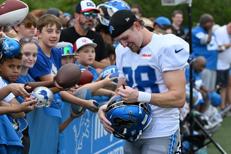 Jul 28, 2025; Allen Park, MI, USA; Detroit Lions safety Dan Jackson (28) signs autographs for fans after training camp at Meijer Performance Center. Mandatory Credit: Lon Horwedel-Imagn Images