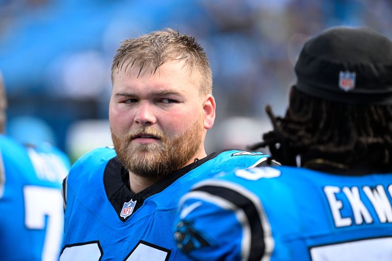 Sep 21, 2025; Charlotte, North Carolina, USA; Carolina Panthers center Cade Mays (64) with offensive tackle Ikem Ekwonu (79) on the sidelines in the fourth quarter at Bank of America Stadium. Mandatory Credit: Bob Donnan-Imagn Images