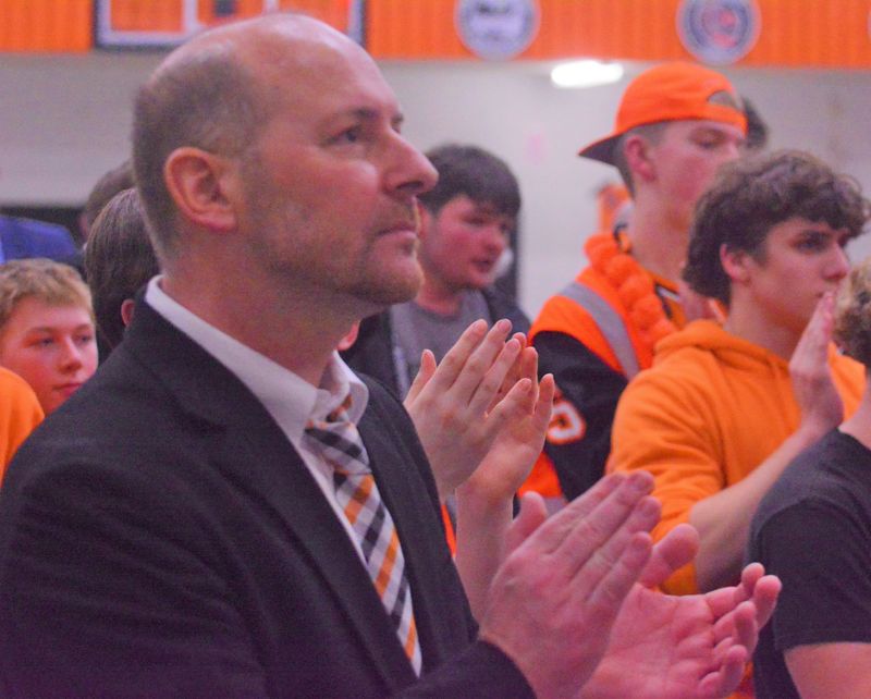 Cheboygan’s Jason Friday looks on as members of his 2025-26 boys basketball team cut down the nets following a district championship victory over Ogemaw Heights at home back in February. Friday, who stepped down as basketball coach shortly after the season ended, is also retiring as a teacher and athletic director at the high school, serving for nearly 30 years.