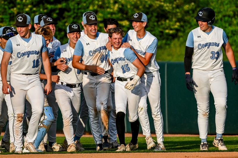 Lansing Catholic's Anothony Branoff, center, celebrates with teammates after beating Haslett on Wednesday, May 27, 2026, in the Diamond Classic semifinal at McLane Stadium in East Lansing.