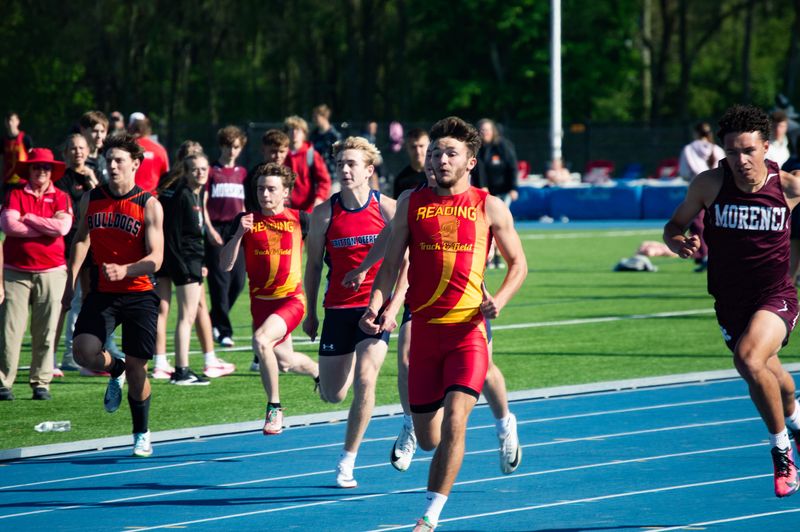 Reading senior Brayden Wright (second from right) chases down a regional title in the 100-meter dash and a new personal best sub-11 time.