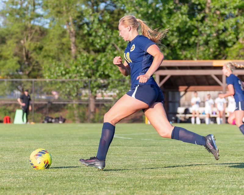 Hartland's Izzy Armstrong pushes the ball up the field during a 4-2 victory over Bloomfield Hills in a district championship soccer game on Thursday, May 28, 2026.