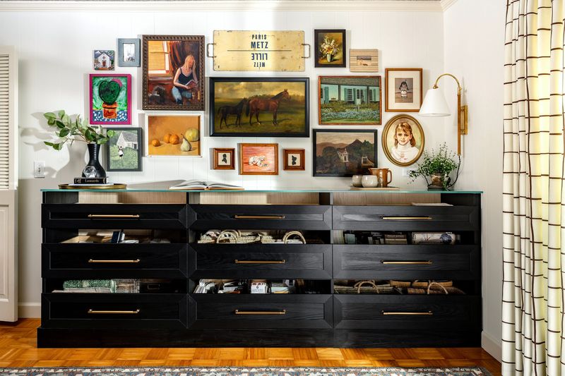 A gallery wall with a Frame TV (shown with a horse picture) makes the screen blend in to the arrangement.
