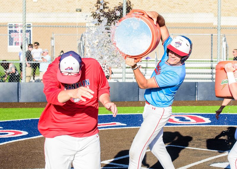 Livonia Franklin's Brendan Bache splashes coach Matt Fournier winning the Division 1 baseball district final on Friday, May 29, 2026.