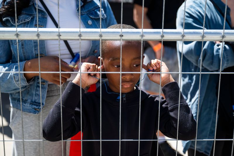 A young fan uses his fingers to plug his ears during the Detroit Grand Prix on Saturday, May 30, 2026 in Detroit.