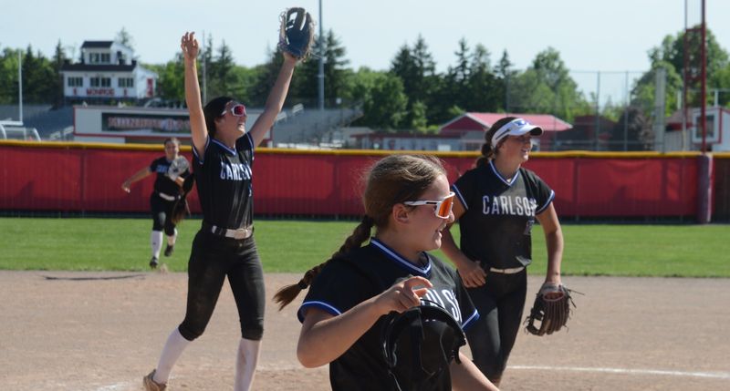 Gibraltar Carlson players celebrate after beating Bedford 10-4 in the finals of the Division 1 Softball District at Monroe on Saturday, May 30, 2026.