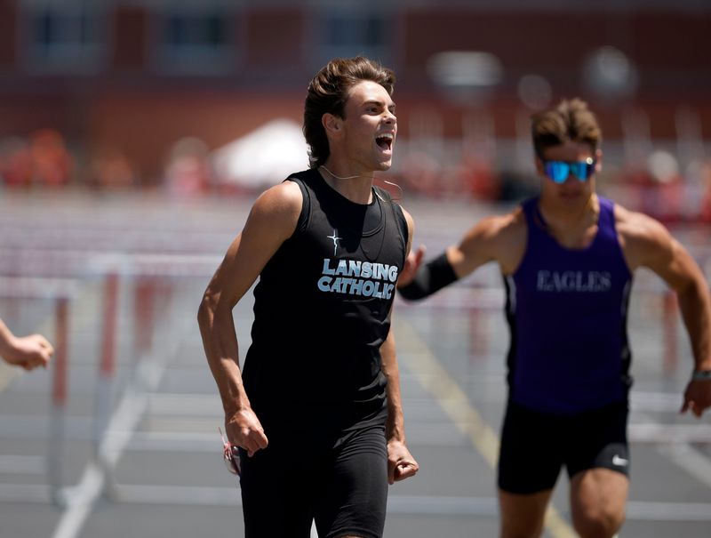 Lansing Catholic's Leland VanAlstine celebrates winning the 110-meter hurdles, Saturday, May 30, 2026, in the MHSAA Division 3 Track Field finals at Kent City High School.