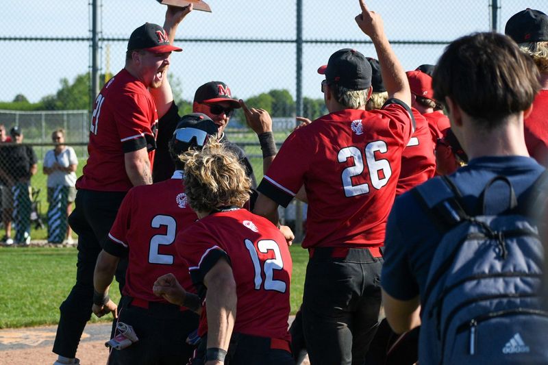 Monroe celebrates a 10-5 victory over Bedford in the finals of the Division 1 District at Saline on Saturday, May 30, 2026.