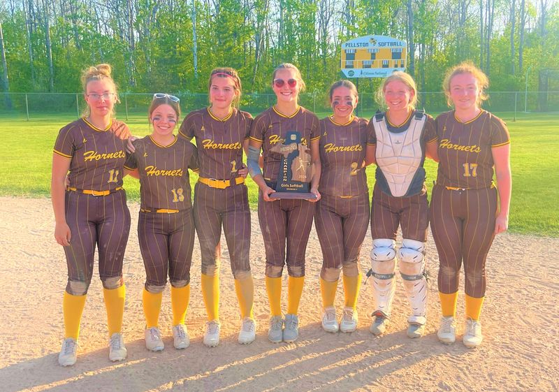 From left, Pellston softball’s senior class of Sadie Keck, Mia Cesaro, Lanie Irwin, Allie Cameron, Breanna Willis, Ella Klungle and Sophia Nicholls were in good spirits after winning an MHSAA Division 4 district championship on their home field on Friday, May 29.