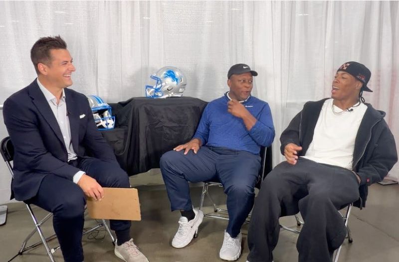 Sportscaster Brad Galli, left, interviews Detroit Lions running backs Barry Sanders, center, and Jahmyr Gibbs during an episode of The Brad Galli Show.