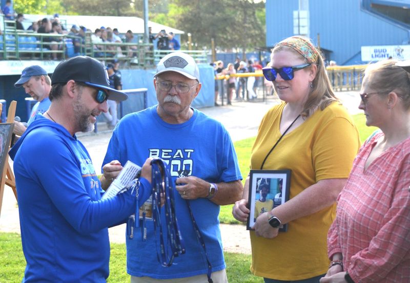 Battle Jacks team owner Scott Miles presents lifetime tickets to former Bombers fans during festivities at the Battle Creek vs. Kalamazoo Growlers game at MCCU Field at C.O. Brown Stadium on Saturday, May 30. A group of fans received tattoos in 2018 with the promise of having lifetime tickets to Bombers games, but those tickets were revoked with the name change for the franchise.