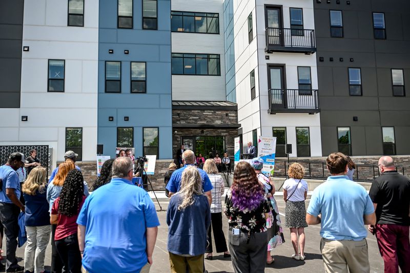 Guests listen as Lansing Housing Commission Executive Director Doug Fleming speaks during a ribbon cutting ceremony for the commission's two new housing projects at the Riverview 220 apartments on Monday, June 1, 2026, in Lansing.